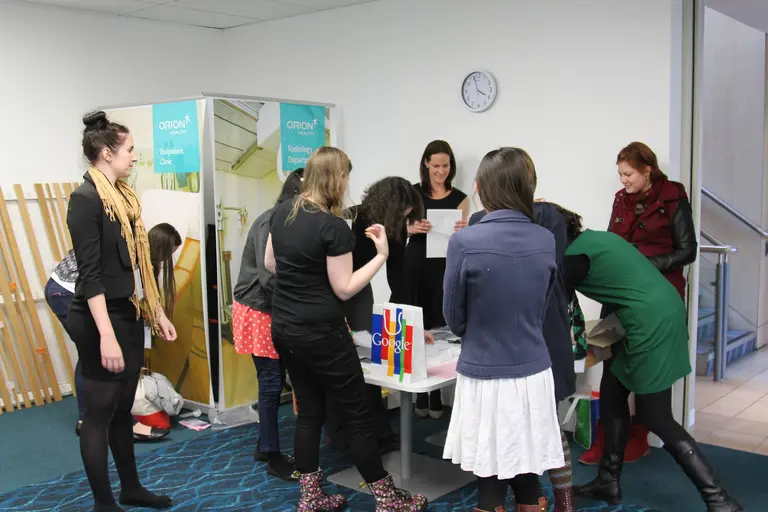 She Sharp community members mingling and networking together in a room at an early She Sharp launch gathering.