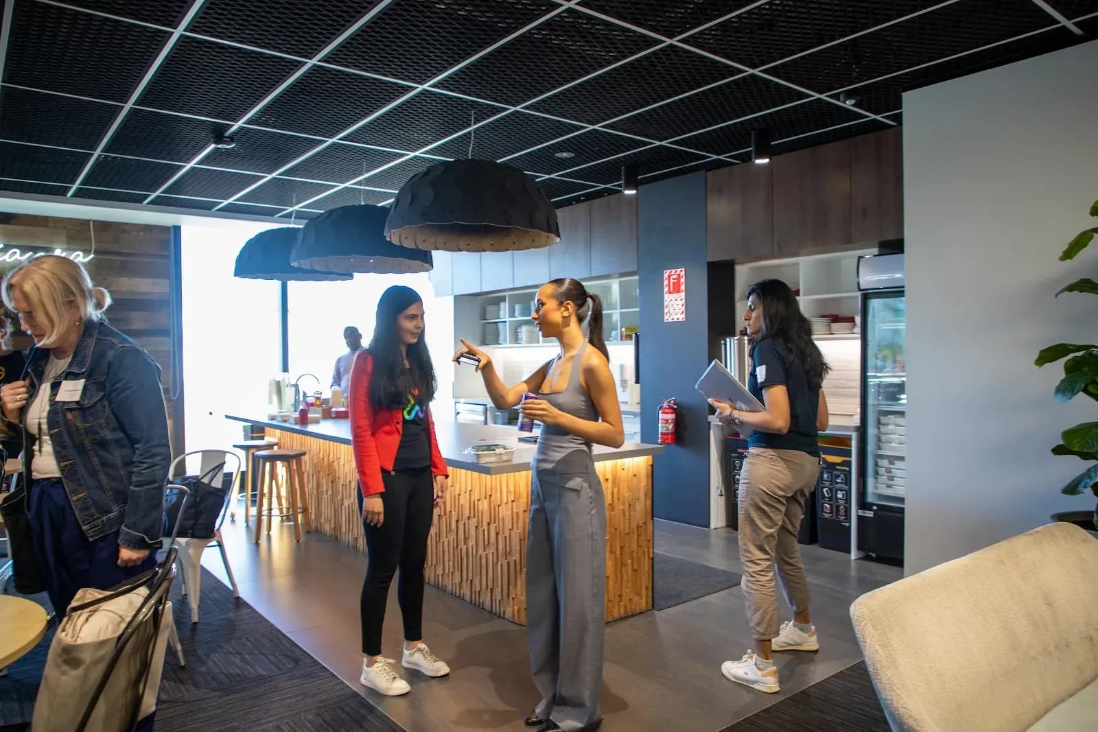 Guests chatting in the Xero office kitchen and breakout area before the evening began
