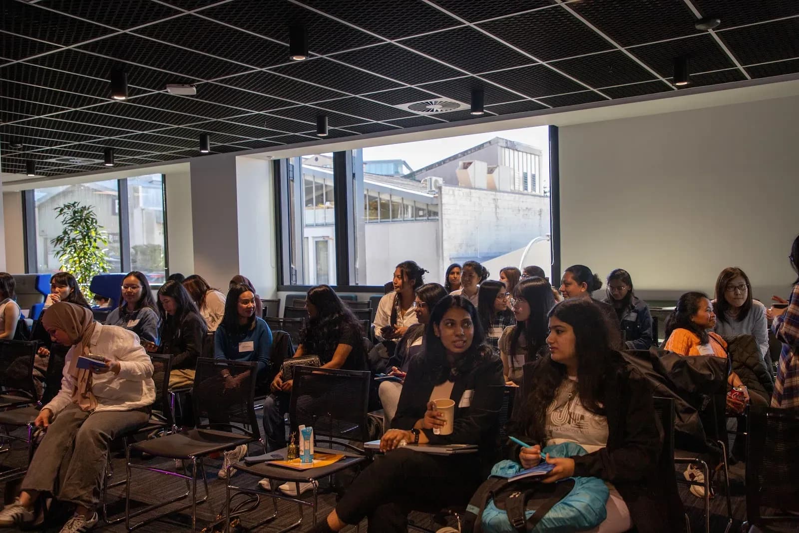 A full room of attendees seated and listening during the evening's programme