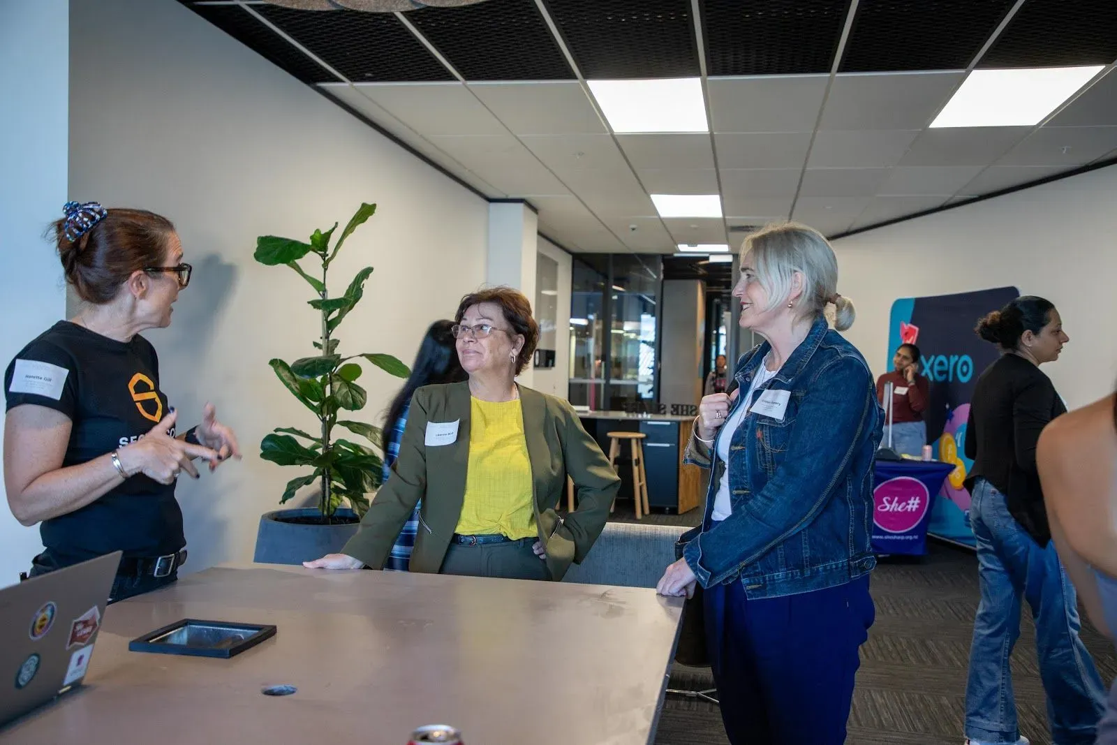 A member of the Secure Code Warrior team chatting with guests around a table before the session